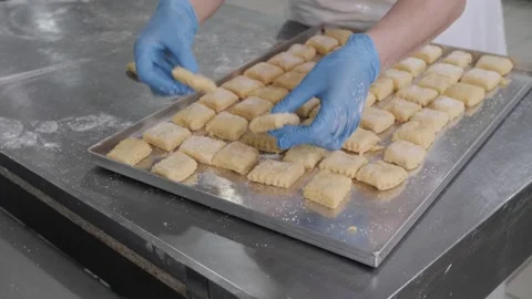 Baker Arranging Pastry Squares on Tray Stock Footage 321544992