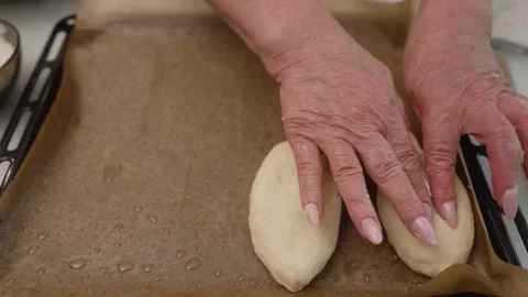 Baker arranging uncooked pies on baking sheet Stock Footage 316541529