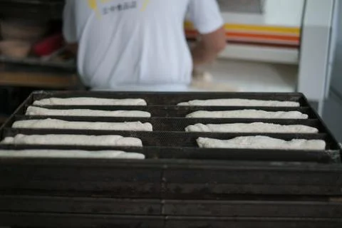 Baker with Back to Soft Rolls Dough Stock Photos