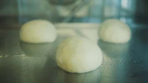 Baker bakes buns in a stove Stock Footage 89526833