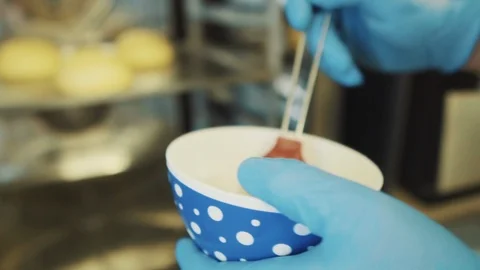 Baker bakes buns in a stove Stock Footage 89527488
