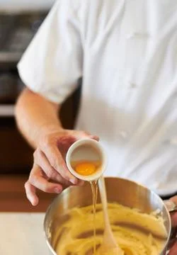 Baker, baking process and egg in batter for cake, confectionery culinary skills 스톡 사진