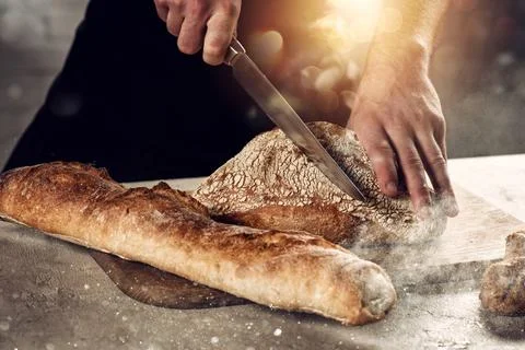 Baker with bread just out of the oven Stock Photos
