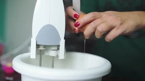 Baker breaks eggs to make the dough making cake Stock Footage 143583845