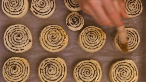 Baker brushing pastries before baking. Close-up. Video stock 101140119