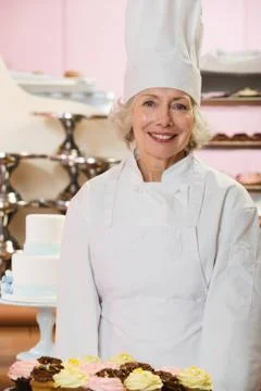 Baker with cakes Stock Photos