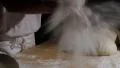 baker clapping with flour powder in hands spotlight 4k or 4k+ Resolution