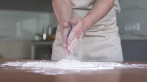 Baker clapping hands with flour while preparing dough for baking homemade bread. Stock Footage 296805491