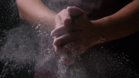 Baker clapping his hands filled with flour, Close-up and slow motion Stock Footage 132678206