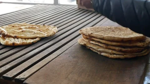 Baker Cleaning Freshly Baked Flatbread with a Small Broom Stock Footage 340304102
