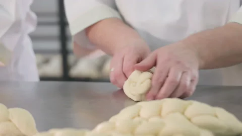 The baker Close up. kneads the dough by hand for making a braided bun. Handmade Stock Footage 237632919