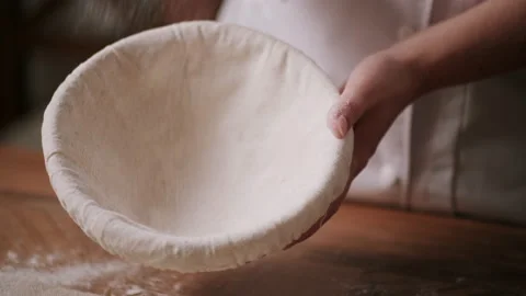 Baker coating a proofing basket with flour Stock Footage 130383494