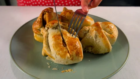 Baker cooking cutting freshly baked dessert wrapped in dough pears with nuts. Stock Footage 313047698