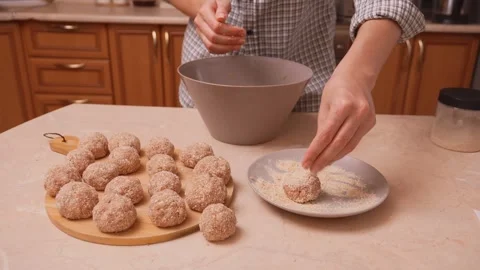 Baker crafts uniform dough balls. Hands dust dough pieces into round balls Stock-Footage 330023150