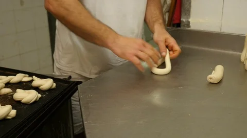 Baker creates forms of pasta for bread with hands Stock Footage 76125856