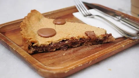 Baker creates a large cookie slice with chocolate pieces Stock Footage 346113988