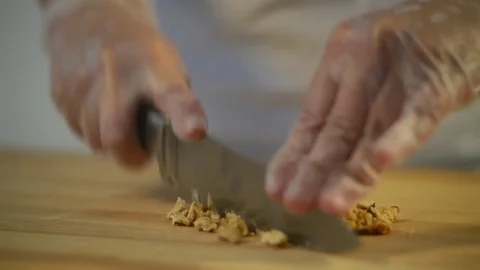 Baker cut with knife Walnuts for a cake Stock Footage 80065831