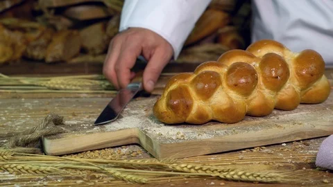 Baker cuts braided bread at the bakery. Stock Footage 109554265