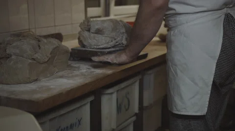 A baker cuts dough into pieces and weighs this then Stock Footage 66438434