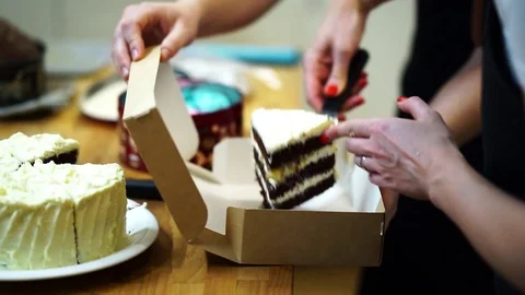 The Baker cuts off a piece of the top cake.  make the cake Video stock 72256637