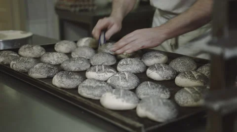 Baker cuts rolls Stock Footage 66438166