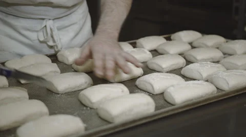 Baker cuts rolls Stock Footage 66438923