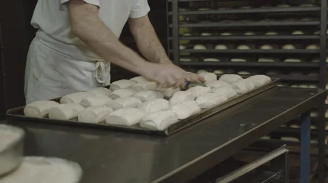 Baker cuts rolls Stock Footage 66438984