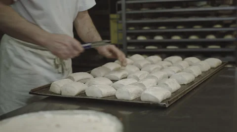 Baker cuts rolls Stock Footage 66441784