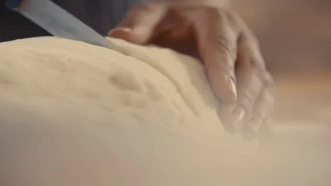 Baker cutting and separating bread dough Stock Footage 274681867