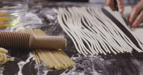 Baker cutting dough and making spaghetti. Stock Footage 138693782