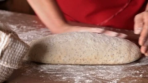 Baker cutting the dough to make buns Stock-Footage 69990776