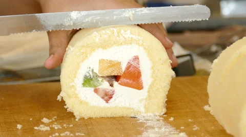 Baker cutting fruit roll cream Stock Footage 65968114