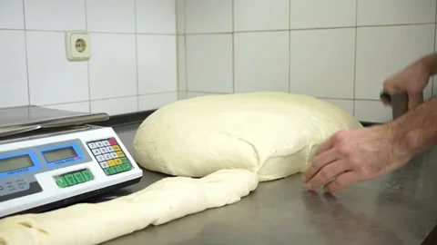 Baker cutting raw burger buns from a kneaded dough 스톡 동영상 251368500