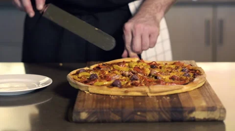 Baker cutting a slice of pizza Stock Footage 66583641
