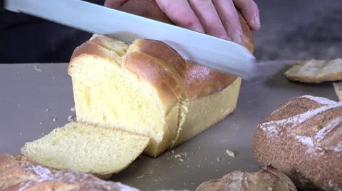 The baker cutting slices of brioche 스톡 동영상 56500982