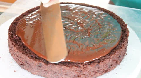 Baker decorated middle layer of chocolate cake Stock Footage 24896740