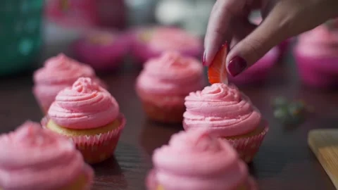 Baker decorates cupcakes with berries Stock Footage 143583933