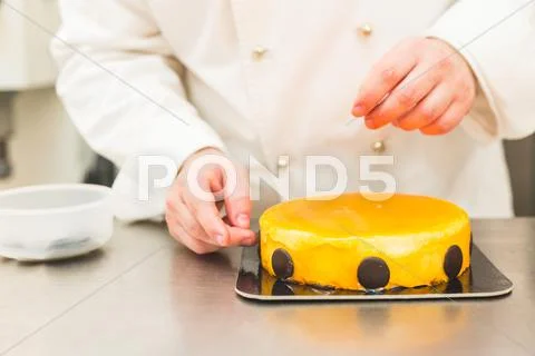 Baker Decorating Cake With Chocolate