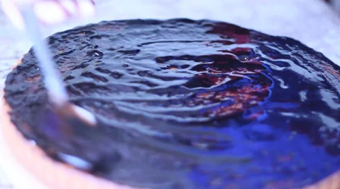 Baker decorating cake with chocolate topping Stock Footage 45286302