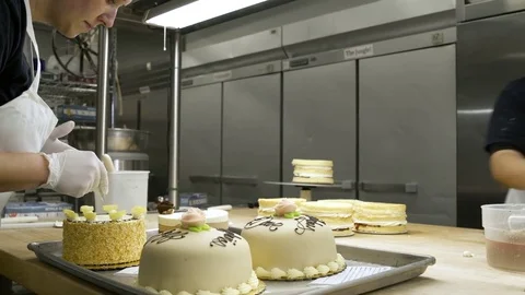 Baker decorating cakes Stock Footage 77080124