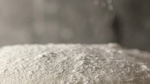 Baker dropping flour onto dough Stock Footage 274688962