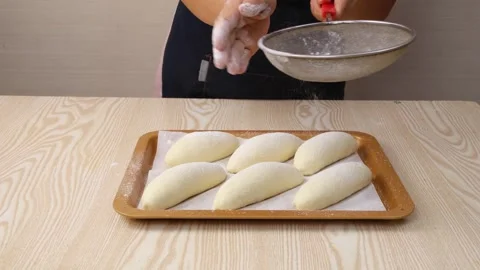 Baker Dusting Flour Over Fresh Bread Dough on Wooden Table 動画素材 342120304