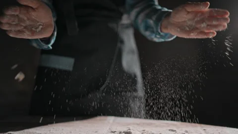 A Baker Dusting Flour On Their Hands In The Kitchen Stock Footage 277246283