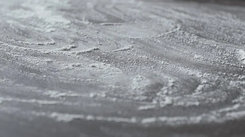 Baker dusting the kitchen worktop with flour 動画素材 127414548