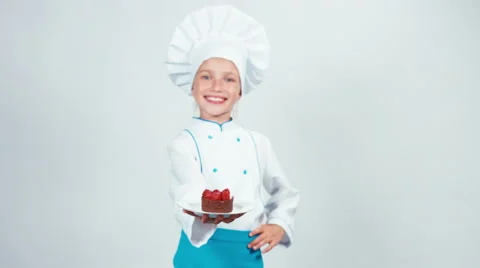Baker enters the frame with chocolate cake and gives you it. Chef smiling Vidéo 67417180