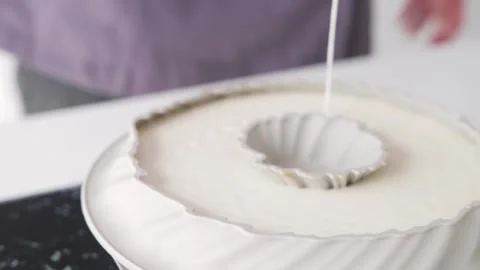 Baker filling the rubber form with a white cream Stock Footage 308225541