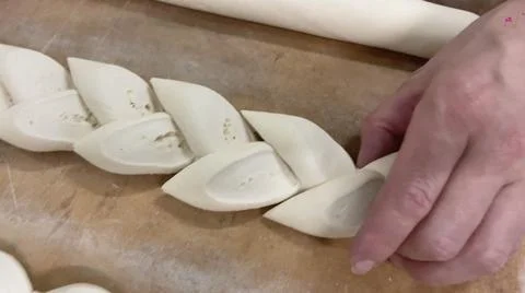 Baker forming the loaf of bread with the cut dough. Concept baker, bread. Stock Photos