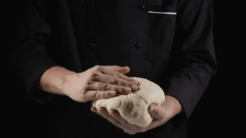 A baker forms a glob of dough, holding it in his hands Stock Footage 170745648