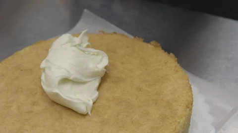 Baker frosting a cake Stock Footage 104866656
