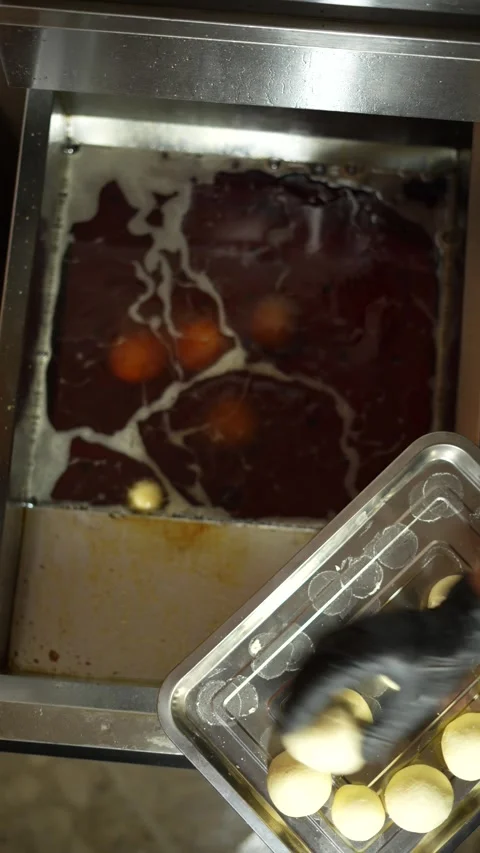 Baker Frying Cheese Buns or Bread in Hot Oil Stock Footage 285862281